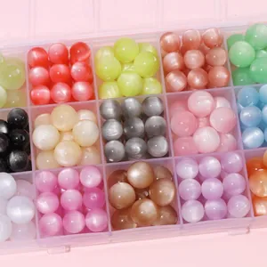 Detailed view of colorful resin cat eye round beads in a multi-compartment storage box