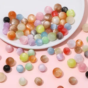 Detailed macro view of colorful resin cat-eye round beads for handmade DIY jewelry crafting