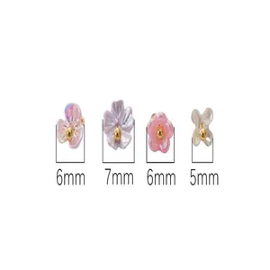 Macro view of mini resin flower charms with gold center showing sizes 5mm to 7mm.
