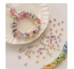 Macro view of various colorful mini resin flower pendants for DIY jewelry making projects