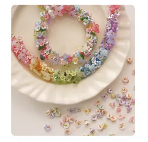 Close-up detail of colorful mini resin flower charms for DIY jewelry and bracelets