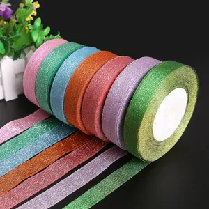 Detailed view of multiple rolls of vibrant glitter ribbons for gift wrapping.