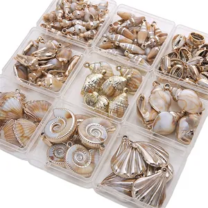 Variety of acrylic faux shell charms with gold plating for DIY jewelry in storage boxes