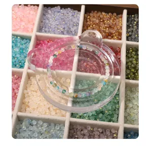 Detailed shot of 7mm colorful frosted glass beads arranged in a velvet grid storage box for DIY