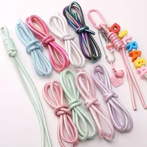 Detailed view of various 6mm braided leather cords featuring custom charms and beads