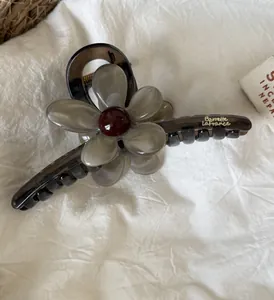 Dettaglio di un fermaglio per capelli in stile coreano con design a fiori marmorizzati