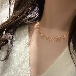 Close-up detail of a delicate gold mesh lace necklace elegantly worn on a model's neck