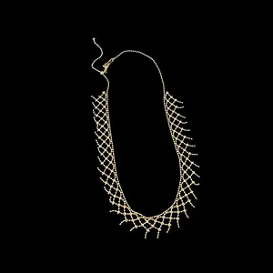 Detailed view of a delicate gold-toned mesh lace necklace with bead chain design.