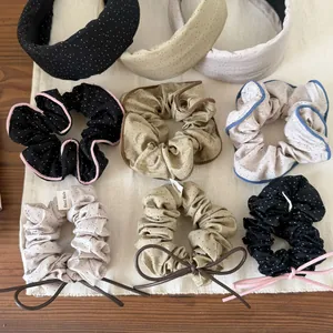 Detail view of assorted polka dot scrunchies and fabric headbands with leather bows.