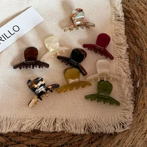 Detail view of mini acetate hair claw clips in French style multi-colors.