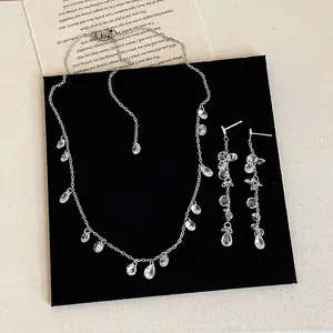 Elegant silver-toned zircon tassel necklace and dangling earrings set for women's fashion