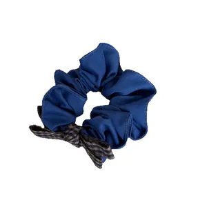 Retro forest style blue scrunchie with a brown checkered bow accent on white background