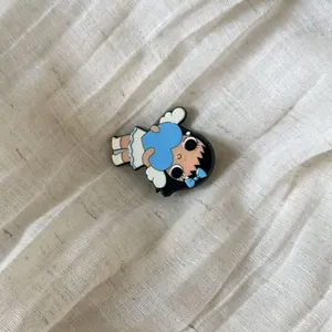 Detailed macro view of a cute cartoon girl accessory with blue heart and ribbon