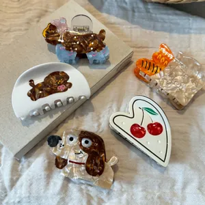 Detailed view of various cute dog and French bread themed acetate hair claw clips