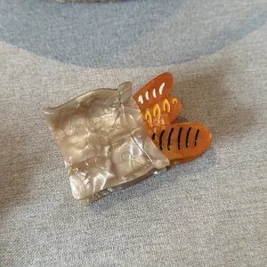 Detailed view of French bread bag acetate hair claw clip with pearlescent finish