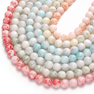 Close-up macro view of 10mm glass beads featuring multi-colored water-dyed porcelain texture.