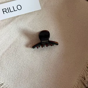 Detail of mini acetate hair claw clip with FRANCE Handmade gold print