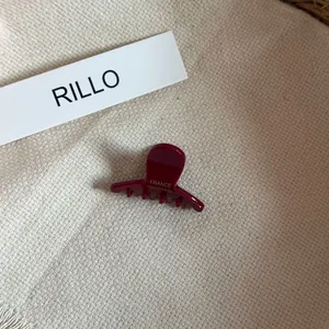 Close-up of small acetate hair claw clip with France Handmade gold lettering