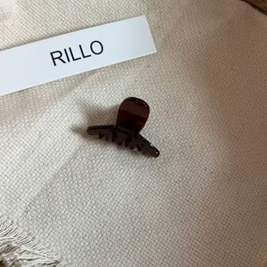 Detailed view of dark chocolate acetate mini hair claw clip with France Handmade text