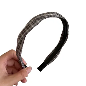 Classic plaid twist headband for women featuring a stylish gingham pattern and comfort fit.