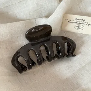 Elegant large dark brown acrylic hair claw clip with a sleek dragon bone design detail