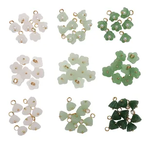Detailed view of assorted glass faux jade flower and bud charms for DIY jewelry