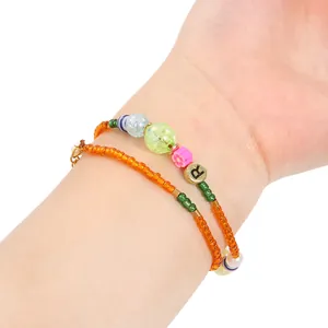 Close-up of colorful acrylic beaded bracelets with AB bubble charms and flower detail