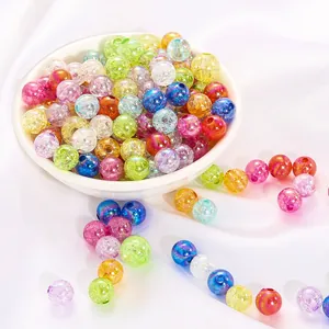 Macro view of colorful iridescent AB acrylic bubble beads scattered on white fabric