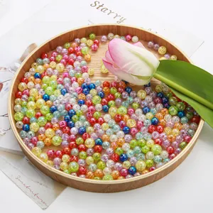Macro view of colorful AB acrylic bubble beads in a rustic wooden tray