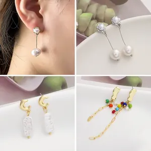 Detail view of assorted alloy drop earrings featuring pearls and colorful beads.