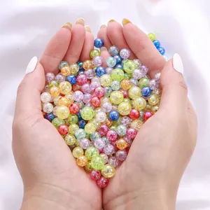 Close-up of colorful macaron acrylic AB bubble beads held in heart-shaped hands for DIY
