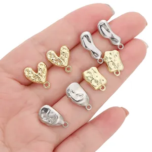 Detailed view of irregular gold and silver alloy DIY earring charms with loops