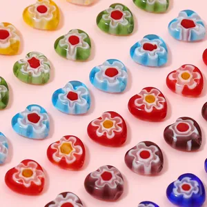 Detailed view of colorful Millefiori heart-shaped glass beads for DIY jewelry making.