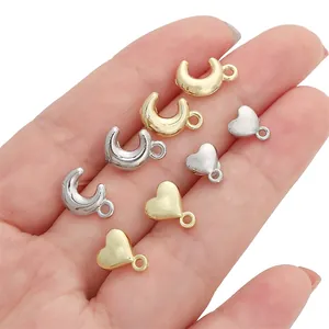 Macro view of gold and silver heart and moon metal charms for DIY jewelry making
