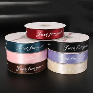 Assorted colors of satin ribbons with Just for you print on rolls for professional gift wrapping