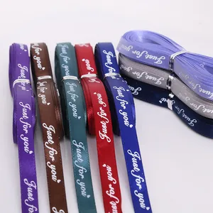 Close-up of multicolored satin ribbons with Just for you printed text for gift wrapping