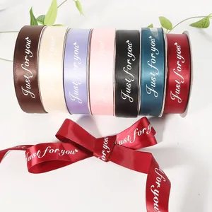 Detail view of multicolored satin ribbons with 'Just for you' printed in elegant cursive.