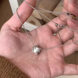 Gedetailleerde close-up van een vintage paleisstijl hanger aan een zilveren ketting