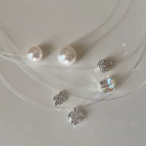Detail view showing zircon, pearl, and crystal pendants on transparent fishing lines