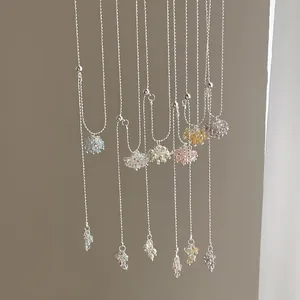 Detail of colorful crystal grape cluster pendants on elegant silver lariat necklaces