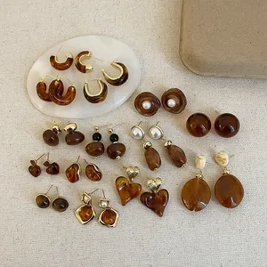 Collection of vintage Maillard coffee brown resin earrings in various artistic shapes.