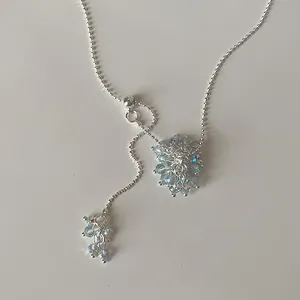 Detailed view of the sparkling crystal grape cluster on an adjustable silver lariat necklace