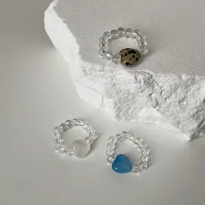 Detailed macro view of elastic beaded rings with Dalmatian jasper and heart stones