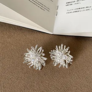 Intricate silver firework stud earrings with pearls and crystal details