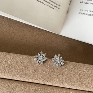 Close-up of elegant silver firework stud earrings with sparkling crystals