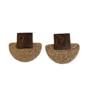 Handmade geometric rattan and wood stud earrings featuring a natural woven texture design