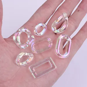 Close-up of various iridescent acrylic chain links for DIY handmade jewelry creation.