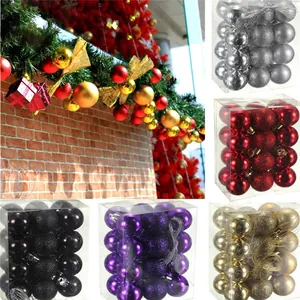 Multi-colored Christmas ornament balls shown in retail boxes and festive garlands.