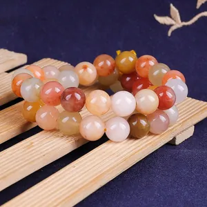 Close-up of polished natural red gold silk jade round beads for DIY jewelry making