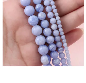 Détail macro de perles rondes en agate synthétique bleu clair pour la création de bijoux DIY